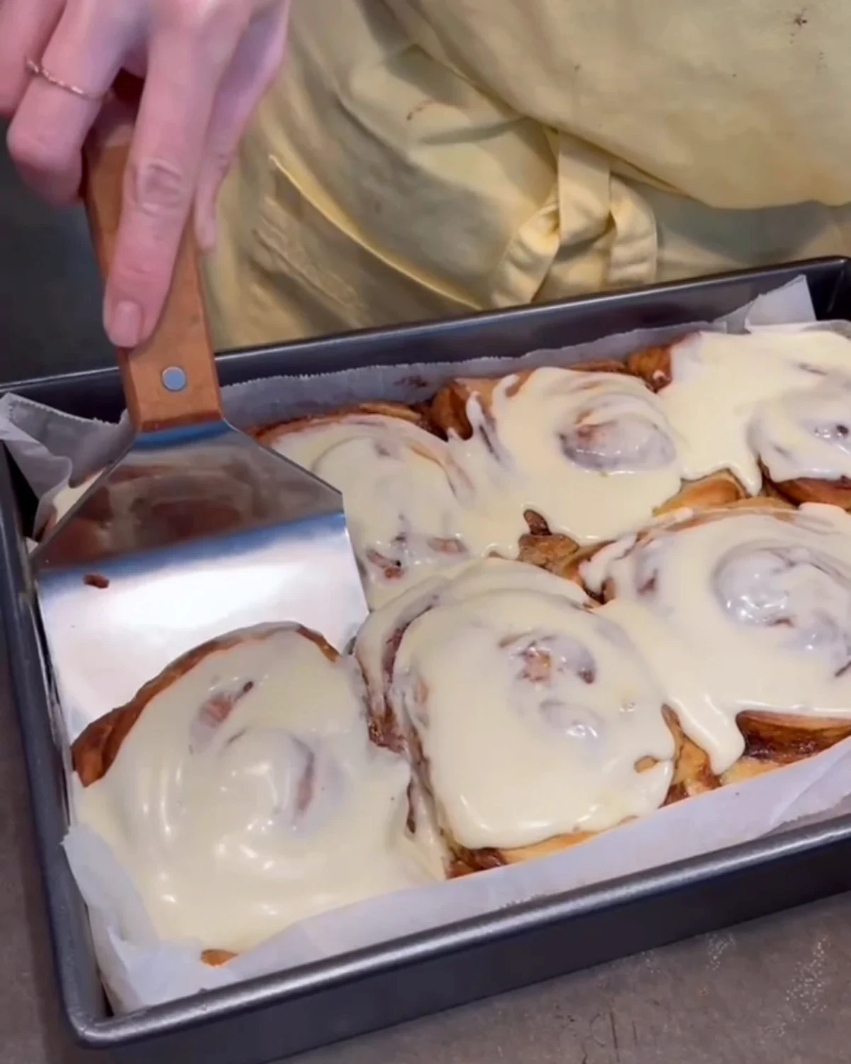Fresh cinnamon scrolls being iced in the Linnie Cafe kitchen