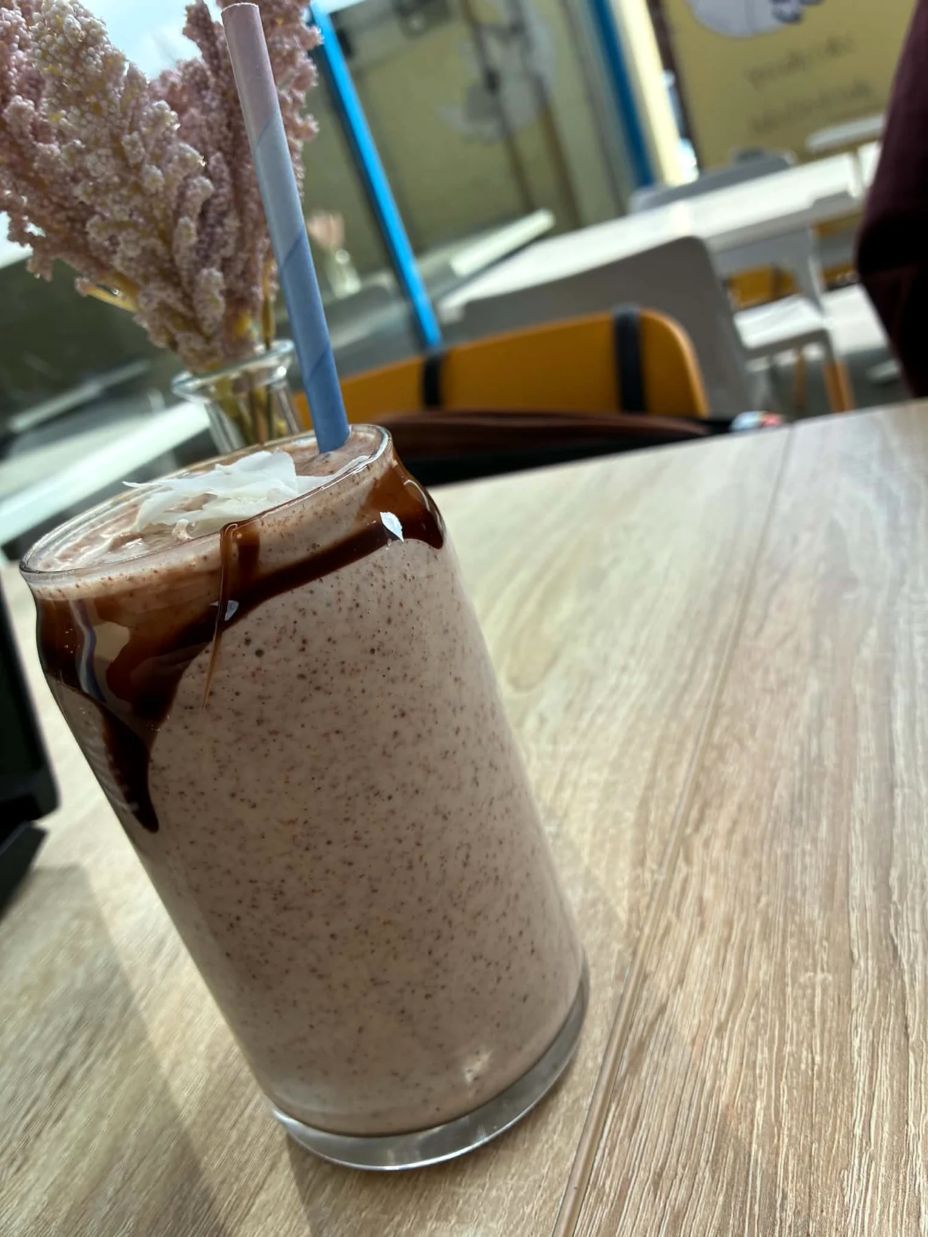 Iced chocolate topped with coconut in a cafe glass