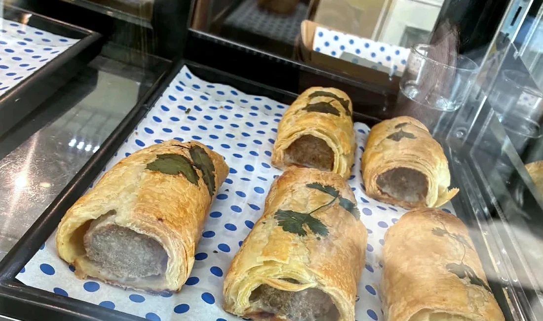 Freshly baked sausage rolls in the pastry cabinet