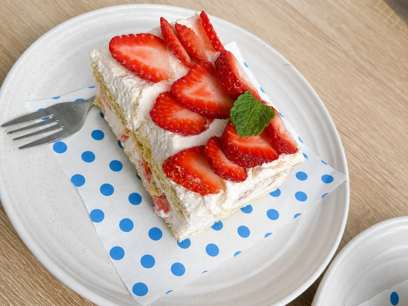 Fresh strawberry cream cake finished with mint